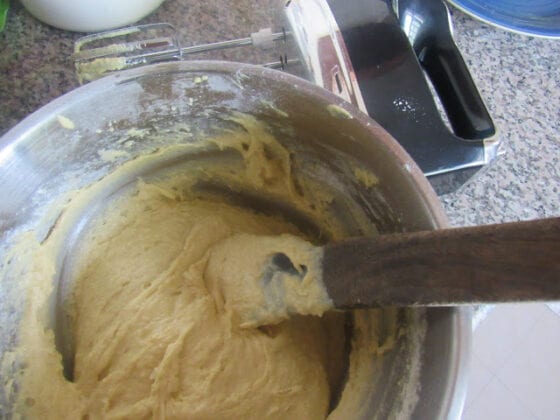 Manually mixing cake batter by folding in with a spoon